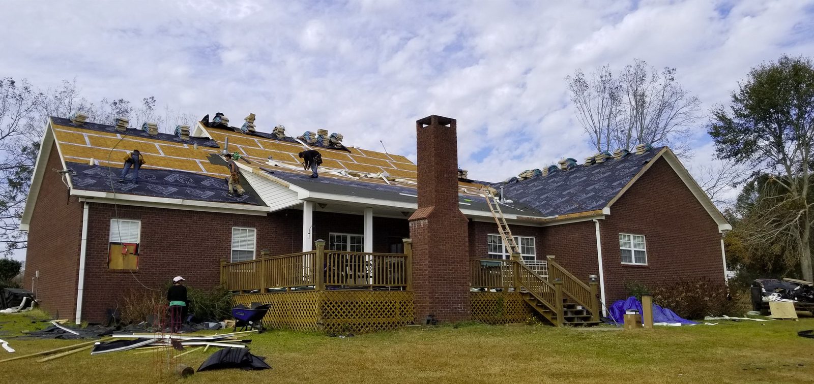 All Phase Roofing crew mid tear-off, decking and underlayment going down