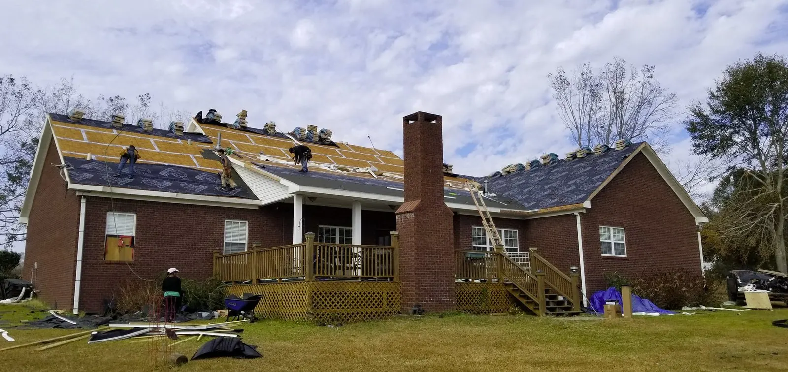 All Phase Roofing crew mid tear-off, decking and underlayment going down